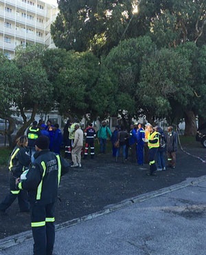 Emergency officials and others stand outside the site of the gas leak. (Supplied by ER24)