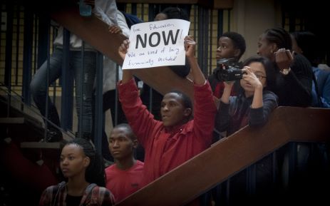 A students holds up a poster at Wits University after the announcement of an 8% increase by Min of Higher Education Nzimande. Picture: Nina Leslie/EWN