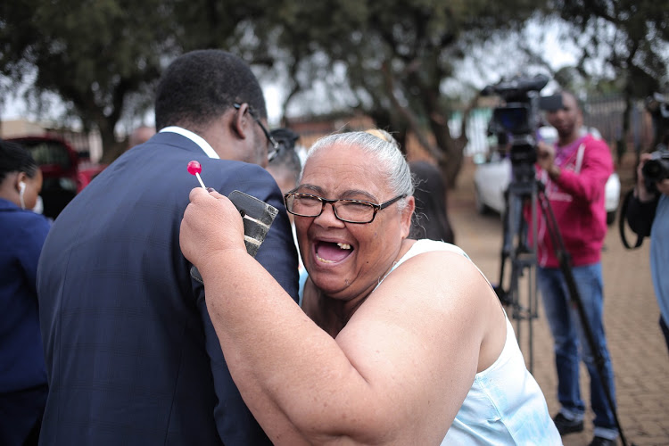 Gauteng Education MEC Penyaza Lesufi is greeted by Rita Davis, a parent at the Klipspruit West Secondary School in Soweto, Johannesburg.