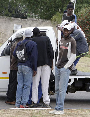 Unemployed men flock into a bakkie with the hope of being chosen for a day job in Midrand. (File: Khaya Ngwenya/City Press)