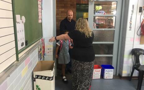 A teacher welcomes a pupil to class on the first day of the 2018 academic year. Picture: Mia Lindeque/EWN