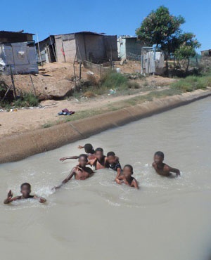  Children swim in the Addo irrigation canal because, they say, they have nowhere else to play. (Joseph Chirume, GroundUp)